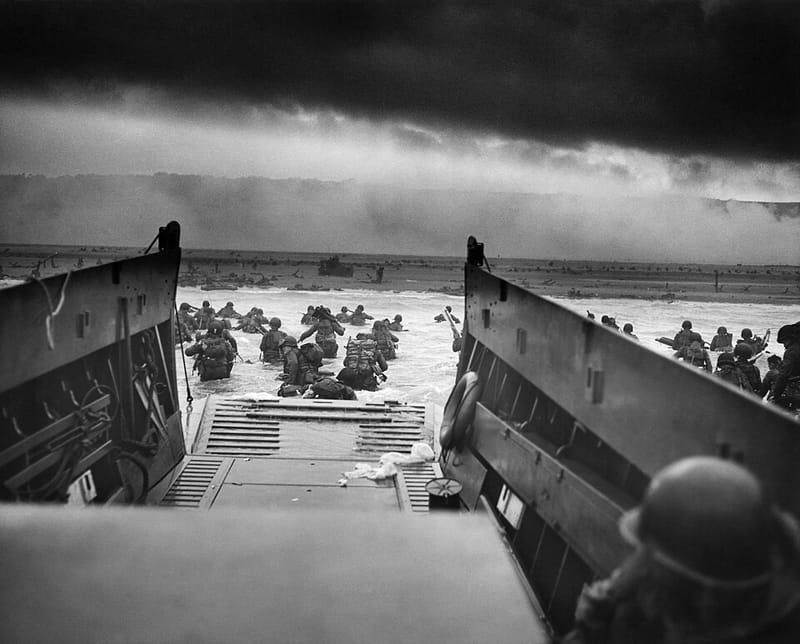 American soldiers wading ashore from a landing craft on Omaha Beach