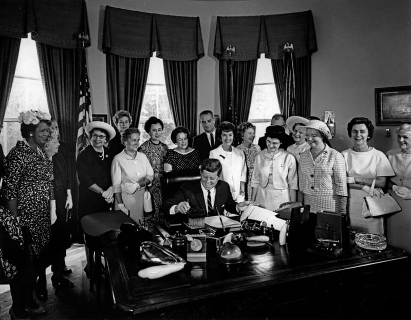 President Kennedy signing the Equal Pay Act with members of the American Association of University Women