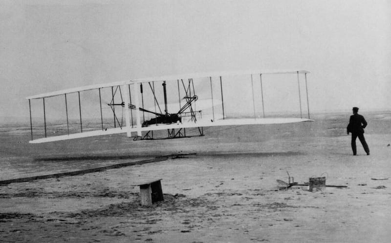 John T. Daniels’s photograph of the Wright Flyer’s first flight on December 17, 1903, with Wilbur Wright running alongside the wingtip